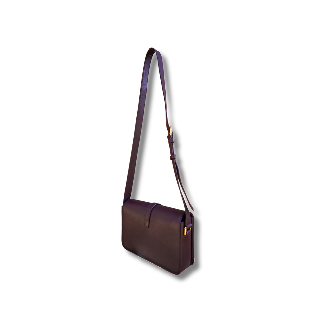 A burgundy Saint Laurent satchel crossbody bag with a gold-finish logo, displayed against a white background