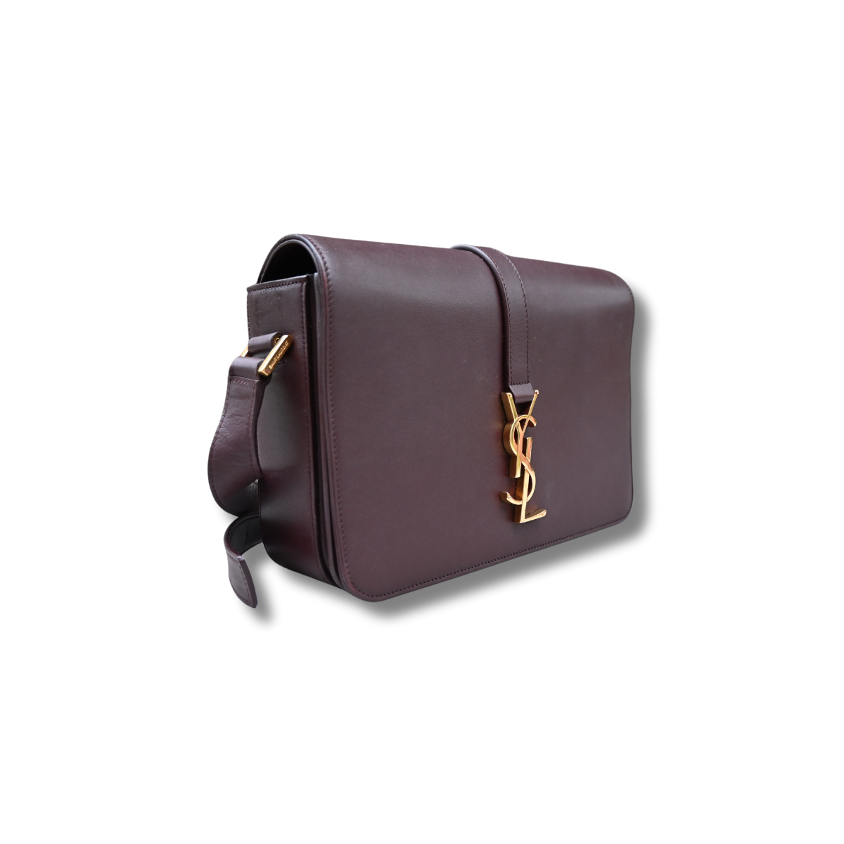A burgundy Saint Laurent satchel crossbody bag with a gold-finish logo, displayed against a white background