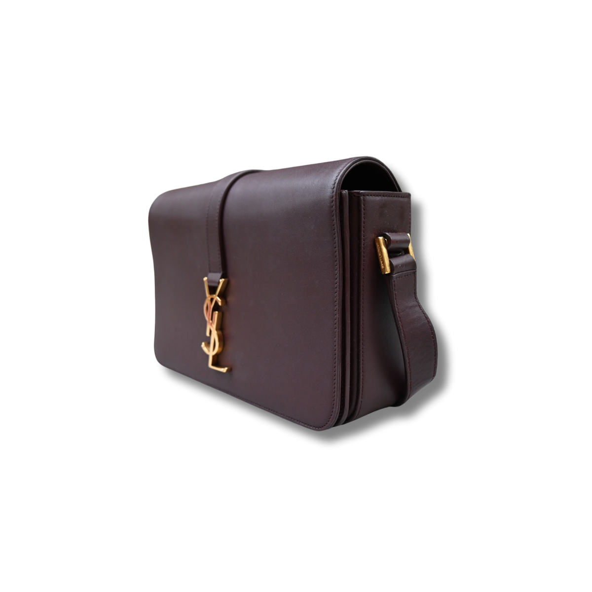 A burgundy Saint Laurent satchel crossbody bag with a gold-finish logo, displayed against a white background