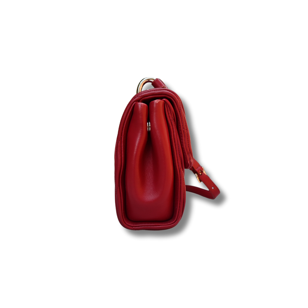 A red Miu Miu matelassé nappa leather shoulder bag with a textured finish, featuring a logo on the front and a chain strap.